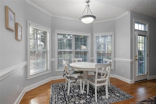 6826 Surrey Rd, Fayetteville, NC 28306 - dining room featuring baseboards, wood finished floors, and crown molding