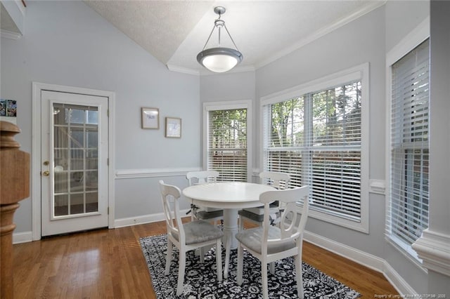 6826 Surrey Rd, Fayetteville, NC 28306 - dining space featuring crown molding, wood finished floors, a textured ceiling, lofted ceiling, and baseboards