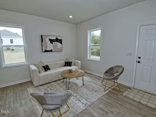 living room featuring recessed lighting, baseboards, and wood finished floors