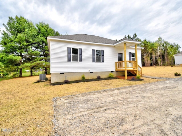 view of front of home with central AC, a shingled roof, and crawl space