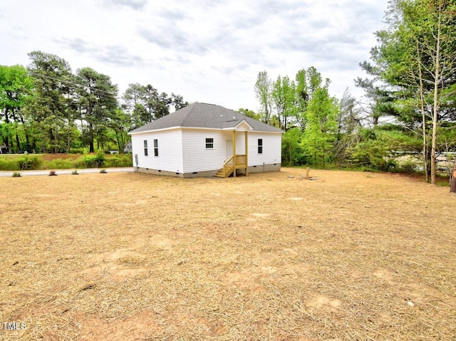 exterior space with crawl space and a shingled roof