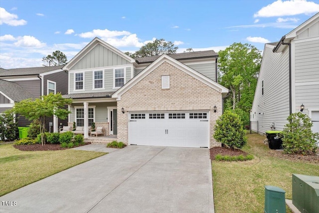 craftsman house featuring a front yard, brick siding, board and batten siding, concrete driveway, and a porch