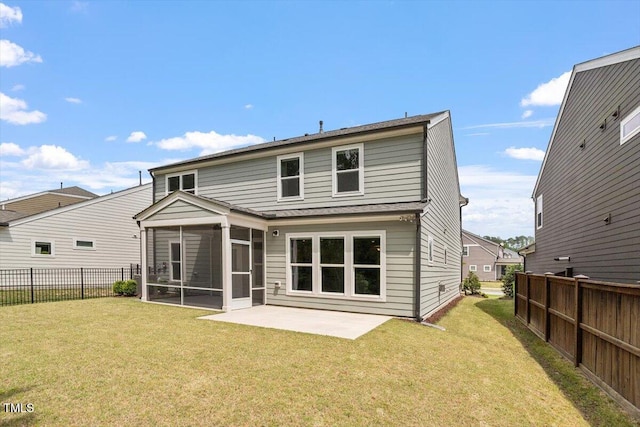 rear view of house with a lawn, a patio, a sunroom, and a fenced backyard