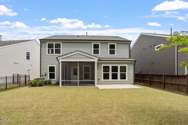 back of house featuring a lawn, a fenced backyard, a sunroom, and a patio area