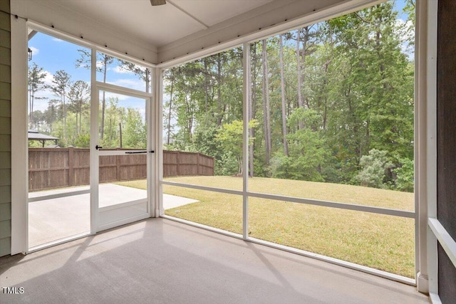 unfurnished sunroom featuring ceiling fan