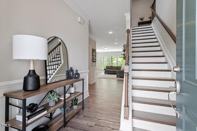 stairs featuring crown molding, recessed lighting, and wood finished floors