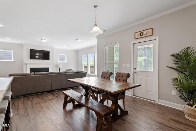 dining area with crown molding, a fireplace, dark wood finished floors, recessed lighting, and baseboards