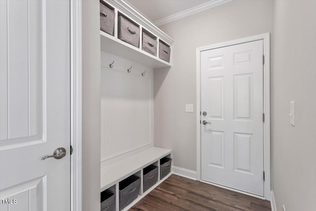 mudroom featuring crown molding, baseboards, and dark wood-type flooring