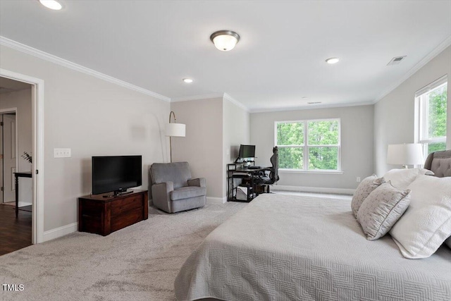bedroom with crown molding, carpet floors, baseboards, and visible vents
