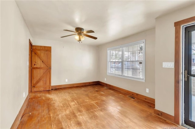 5213 Palmetto Ln, Fayetteville, NC 28304 - empty room with wood finished floors, ceiling fan, baseboards, and visible vents