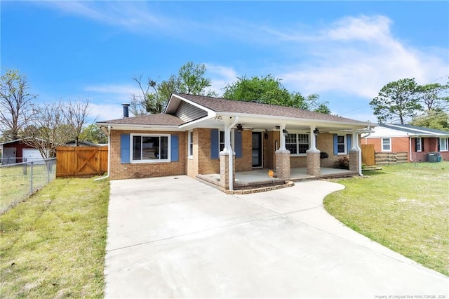 5213 Palmetto Ln, Fayetteville, NC 28304 - ranch-style house with a ceiling fan, fence, concrete driveway, brick siding, and a front lawn