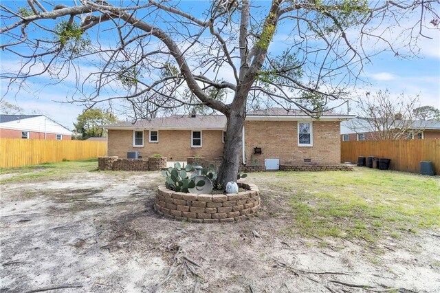 5213 Palmetto Ln, Fayetteville, NC 28304 - rear view of property featuring brick siding, crawl space, fence, and a lawn