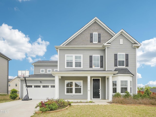 traditional-style house featuring a garage, a front lawn, covered porch, and concrete driveway