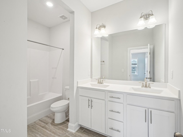 bathroom with visible vents, a sink, double vanity, and toilet