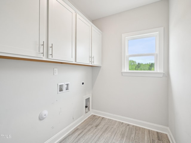 laundry area with hookup for an electric dryer, hookup for a gas dryer, baseboards, cabinet space, and washer hookup