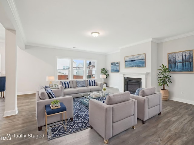 living area with baseboards, crown molding, a glass covered fireplace, and wood finished floors