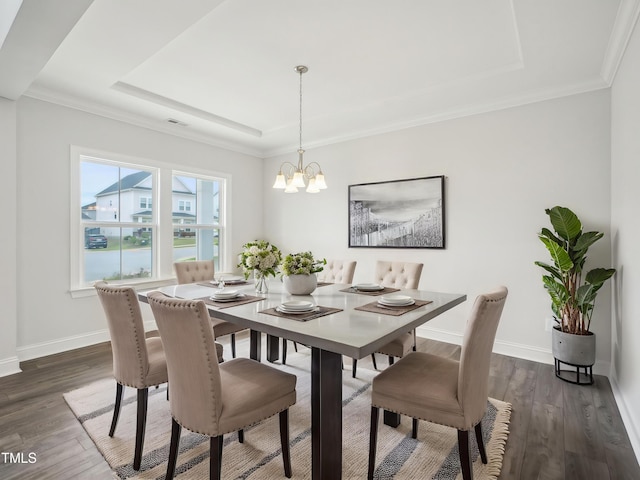 dining room featuring a tray ceiling, visible vents, dark wood-type flooring, baseboards, and a notable chandelier