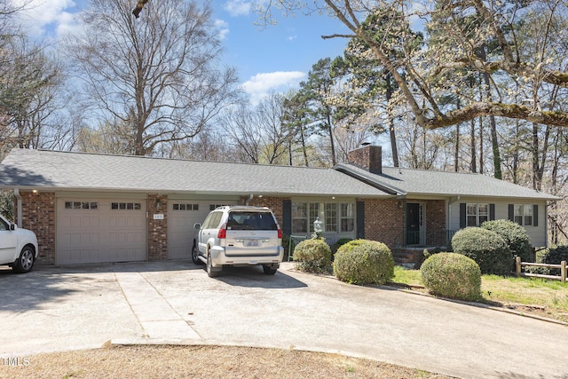 105 Elizabeth St, Chapel Hill, NC 27514 - single story home with an attached garage, a chimney, concrete driveway, and brick siding