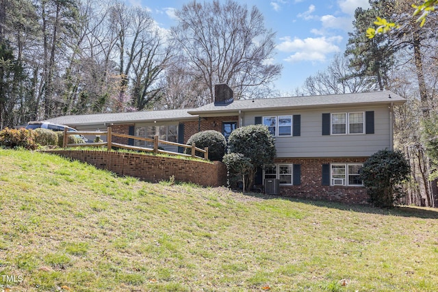 105 Elizabeth St, Chapel Hill, NC 27514 - view of front of house featuring a chimney, cooling unit, brick siding, and a front yard