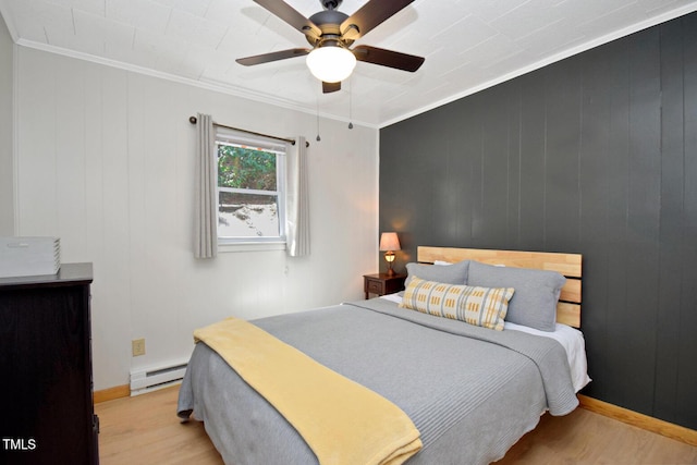1471 Bamboo Rd, Boone, NC 28607 - bedroom featuring a baseboard heating unit, wood finished floors, ornamental molding, and ceiling fan