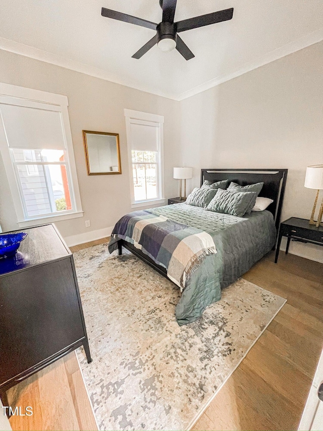 14 Duck Bill Trl, Pittsboro, NC 27312 - bedroom featuring ornamental molding, wood finished floors, multiple windows, a ceiling fan, and baseboards