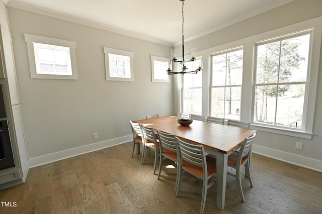 14 Duck Bill Trl, Pittsboro, NC 27312 - dining room with a chandelier, crown molding, baseboards, and wood finished floors