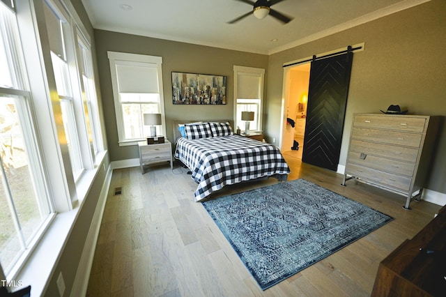 14 Duck Bill Trl, Pittsboro, NC 27312 - bedroom featuring a barn door, wood finished floors, baseboards, crown molding, and ceiling fan