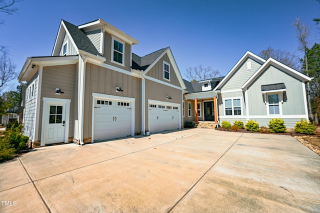 14 Duck Bill Trl, Pittsboro, NC 27312 - view of front of property with board and batten siding, an attached garage, a shingled roof, and driveway