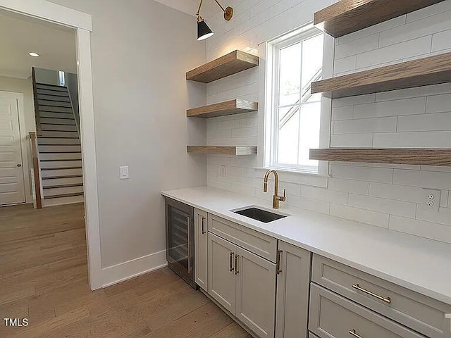 14 Duck Bill Trl, Pittsboro, NC 27312 - kitchen with open shelves, wine cooler, light wood-style floors, and baseboards