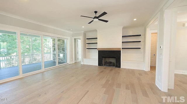 14 Duck Bill Trl, Pittsboro, NC 27312 - unfurnished living room featuring light wood finished floors, a ceiling fan, a fireplace, baseboards, and crown molding