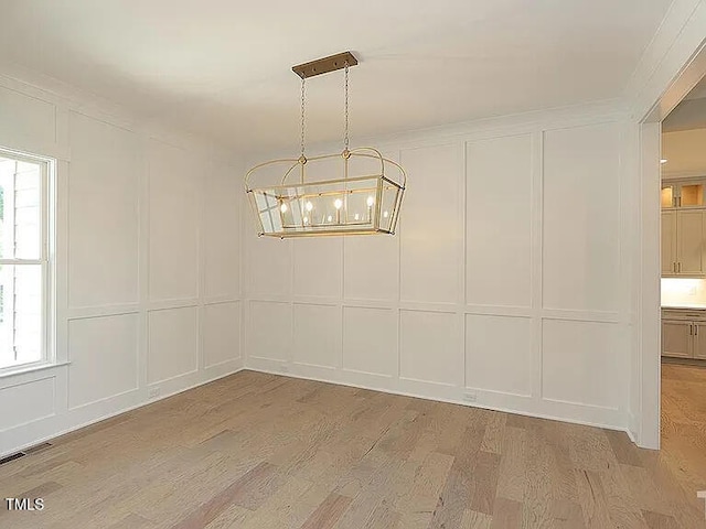 14 Duck Bill Trl, Pittsboro, NC 27312 - unfurnished room with a decorative wall, a chandelier, light wood-type flooring, and plenty of natural light