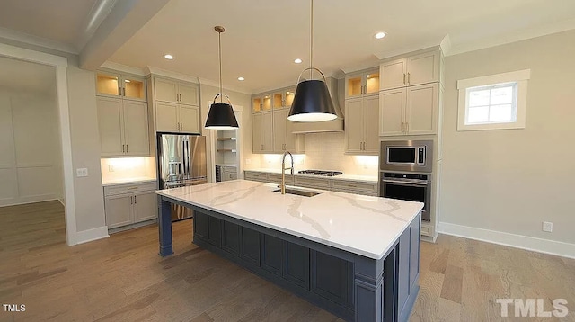 14 Duck Bill Trl, Pittsboro, NC 27312 - kitchen with appliances with stainless steel finishes, a sink, backsplash, a center island with sink, and light wood-style floors