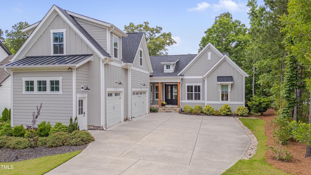 14 Duck Bill Trl, Pittsboro, NC 27312 - modern farmhouse featuring board and batten siding, an attached garage, driveway, and a standing seam roof