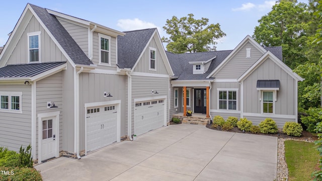 14 Duck Bill Trl, Pittsboro, NC 27312 - view of front of house with board and batten siding, concrete driveway, a shingled roof, a garage, and a standing seam roof