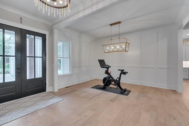 14 Duck Bill Trl, Pittsboro, NC 27312 - foyer entrance featuring a chandelier, a decorative wall, french doors, plenty of natural light, and light wood-style flooring