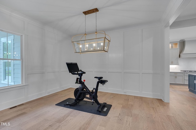 14 Duck Bill Trl, Pittsboro, NC 27312 - workout room with a decorative wall, light wood-type flooring, a chandelier, and ornamental molding