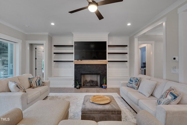 14 Duck Bill Trl, Pittsboro, NC 27312 - living area featuring wood finished floors, a ceiling fan, ornamental molding, recessed lighting, and a premium fireplace