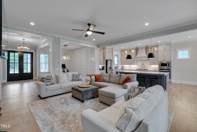 14 Duck Bill Trl, Pittsboro, NC 27312 - living room featuring ornamental molding, light wood-style floors, a chandelier, baseboards, and ceiling fan