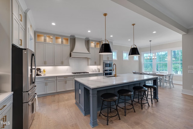 14 Duck Bill Trl, Pittsboro, NC 27312 - kitchen featuring appliances with stainless steel finishes, premium range hood, light wood-type flooring, tasteful backsplash, and a breakfast bar