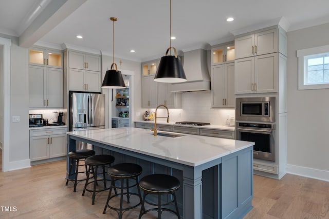 14 Duck Bill Trl, Pittsboro, NC 27312 - kitchen featuring appliances with stainless steel finishes, a sink, light wood-type flooring, decorative backsplash, and a kitchen breakfast bar
