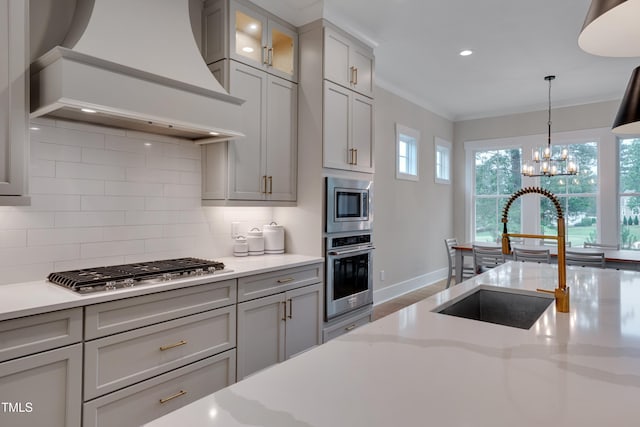 14 Duck Bill Trl, Pittsboro, NC 27312 - kitchen with stainless steel appliances, custom range hood, a sink, decorative backsplash, and crown molding