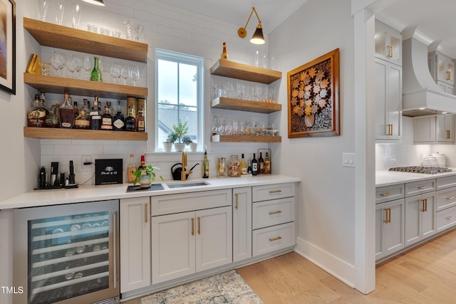 14 Duck Bill Trl, Pittsboro, NC 27312 - indoor bar featuring beverage cooler, tasteful backsplash, premium range hood, light wood finished floors, and stainless steel gas stovetop