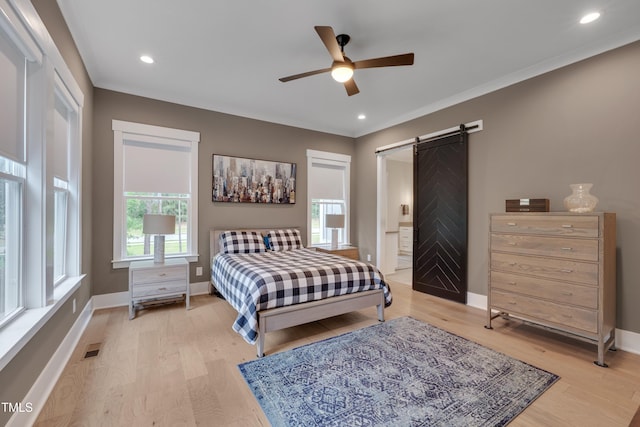 14 Duck Bill Trl, Pittsboro, NC 27312 - bedroom with a barn door, light wood-style floors, baseboards, and recessed lighting