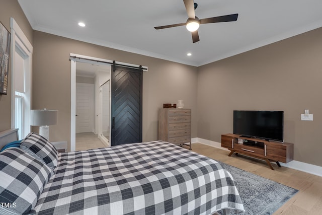 14 Duck Bill Trl, Pittsboro, NC 27312 - bedroom with a barn door, ornamental molding, recessed lighting, baseboards, and light wood finished floors