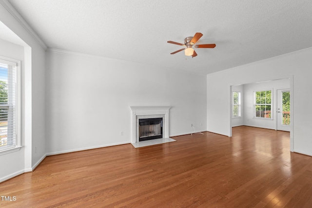 1308 Aspen Falls Ct, Willow Springs, NC 27592 - unfurnished living room featuring crown molding, a textured ceiling, ceiling fan, and wood finished floors