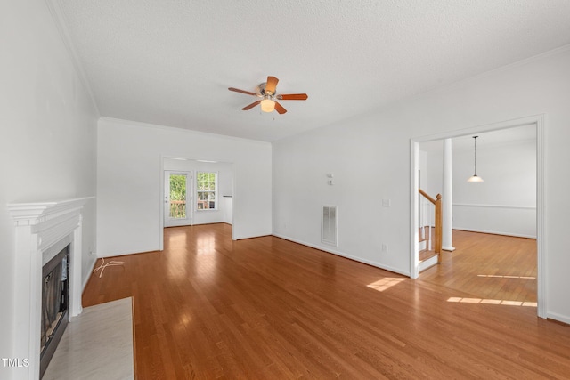 1308 Aspen Falls Ct, Willow Springs, NC 27592 - unfurnished living room with ceiling fan, a fireplace with flush hearth, visible vents, and light wood-type flooring