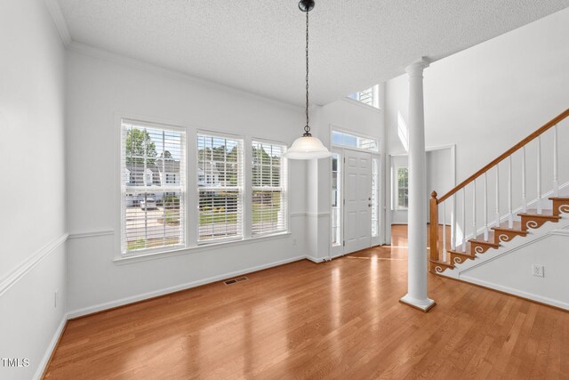 1308 Aspen Falls Ct, Willow Springs, NC 27592 - unfurnished dining area with visible vents, wood finished floors, baseboards, stairway, and a textured ceiling