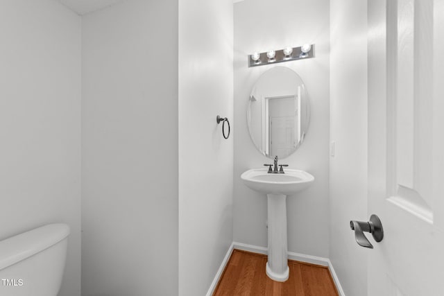 1308 Aspen Falls Ct, Willow Springs, NC 27592 - bathroom with baseboards, wood finished floors, and toilet
