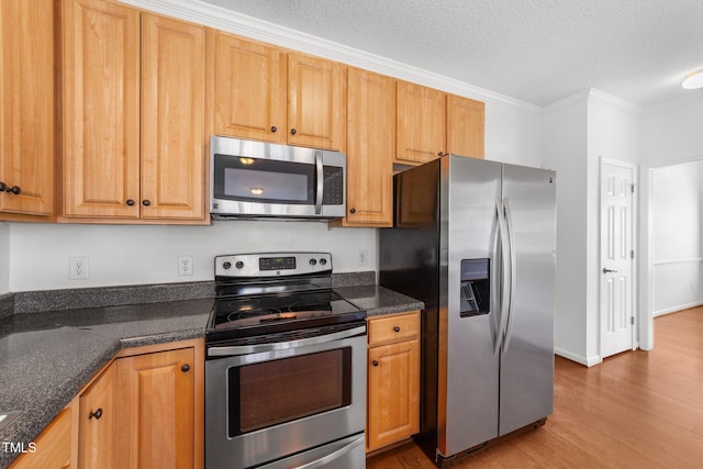 1308 Aspen Falls Ct, Willow Springs, NC 27592 - kitchen with ornamental molding, a textured ceiling, wood finished floors, and stainless steel appliances