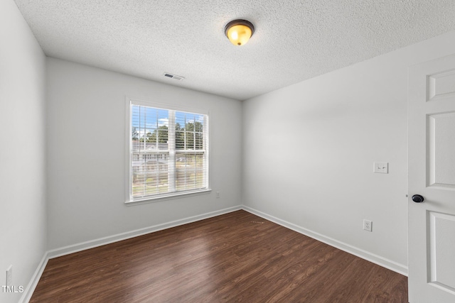 1308 Aspen Falls Ct, Willow Springs, NC 27592 - empty room with a textured ceiling, visible vents, dark wood-style floors, and baseboards